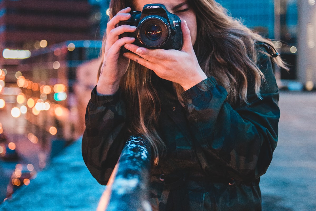 A creator photographing content with a professional camera at golden hour